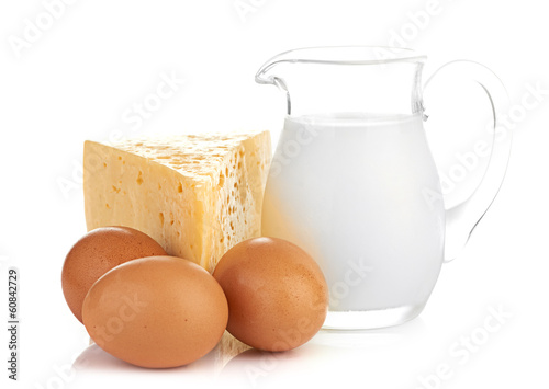 Photo: Big piece of cheese, glass jug with milk Big piece of cheese, glass jug with milk