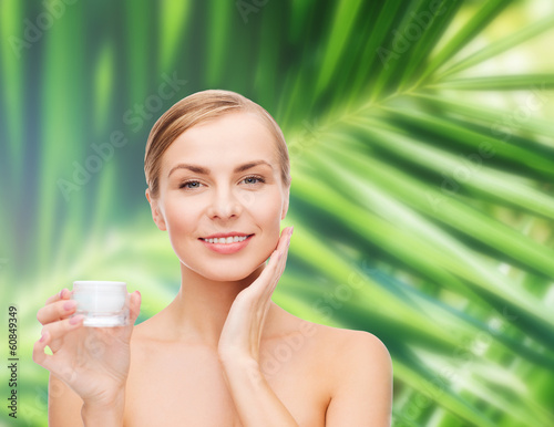 Photo: woman applying cream on her skin woman applying cream on her skin