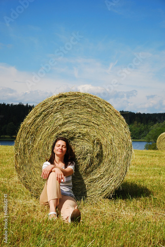 Photo: Woman sitting down the stubble-field Woman sitting down the stubble-field