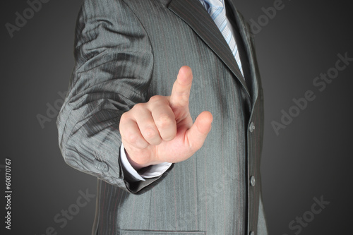 Photo: Man pushes icon on dark background Man pushes icon on dark background