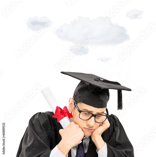Photo: Sad graduate student holding diploma with a cloud over his head Sad graduate student holding diploma with a cloud over his head