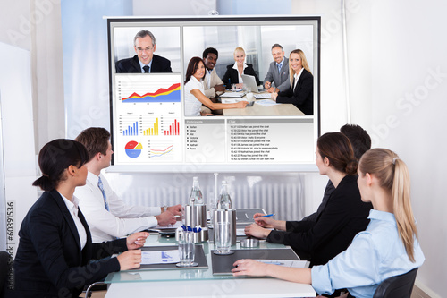 Photo: Businesspeople In Video Conference At Business Meeting Businesspeople In Video Conference At Business Meeting