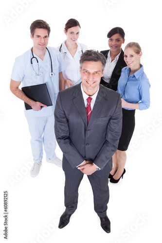 Photo: Businessman In Front Of Professional Workers Businessman In Front Of Professional Workers