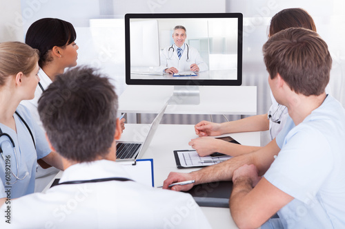 Photo: Doctors Watching Online Presentation Doctors Watching Online Presentation