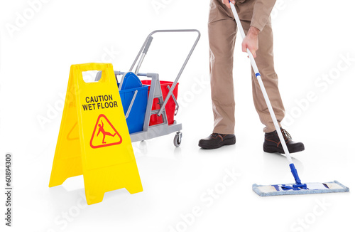 Photo: Sweeper Cleaning Floor With Warning Sign Sweeper Cleaning Floor With Warning Sign