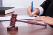 Male Judge Writing On Paper Male Judge Writing On Paper