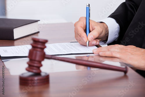 Photo: Male Judge Writing On Paper Male Judge Writing On Paper