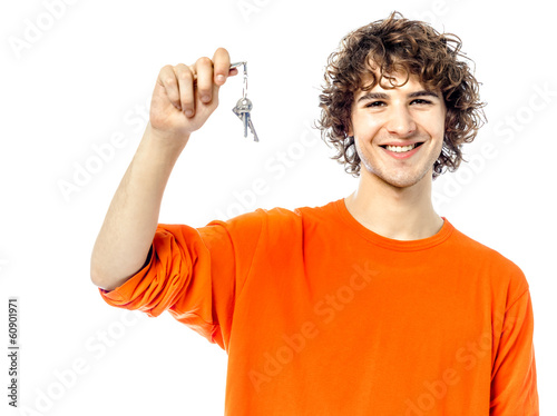 Photo: young man holding keys portrait young man holding keys portrait