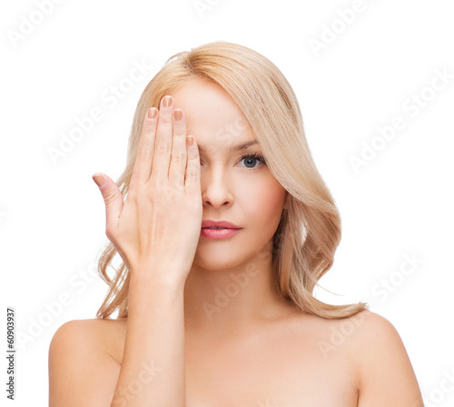 Photo: beautiful woman covering half of face with hand beautiful woman covering half of face with hand