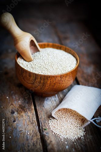Photo: White quinoa on rustic wooden background White quinoa on rustic wooden background