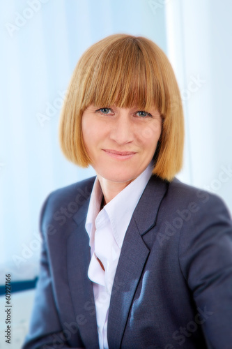 Photo: Portrait of friendly business woman Portrait of friendly business woman
