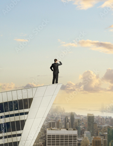 Photo: businessman standing on roof businessman standing on roof