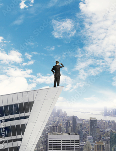 Photo: man standing on roof man standing on roof