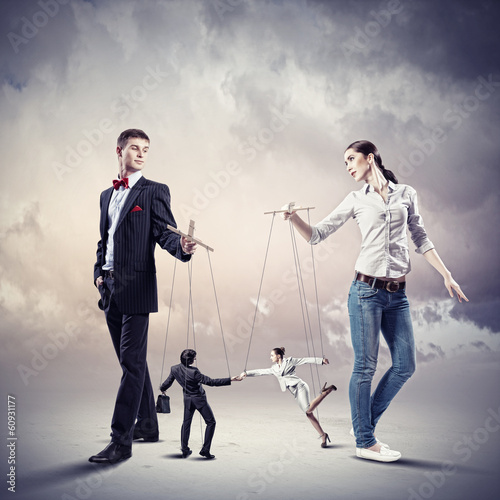 Photo: Businesspeople with marionettes Businesspeople with marionettes