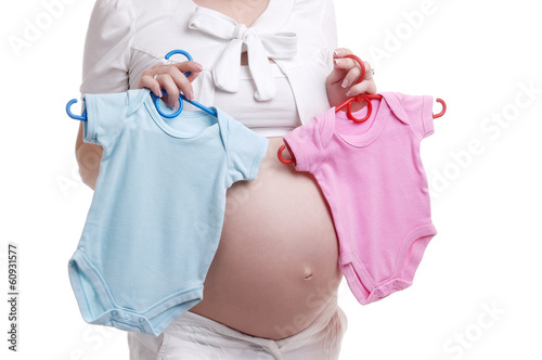 Photo: Pregnant woman holding bodysuit for a baby girl and boy Pregnant woman holding bodysuit for a baby girl and boy