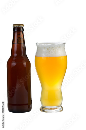 Photo: Unopened bottle of beer along with a full glass of beer Unopened bottle of beer along with a full glass of beer