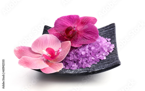 Photo: Beautiful blooming orchid flowers and heap of sea salt Beautiful blooming orchid flowers and heap of sea salt