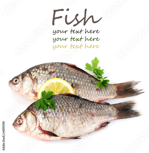 Photo: Fresh fishes with lemon and parsley isolated on white Fresh fishes with lemon and parsley isolated on white