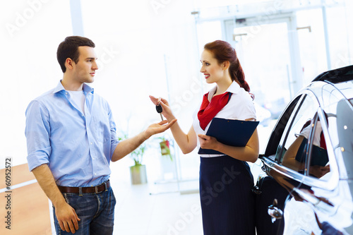 Photo: Young man at car salon Young man at car salon