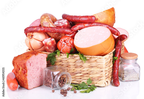 Photo: Lot of different sausages in basket isolated on white Lot of different sausages in basket isolated on white