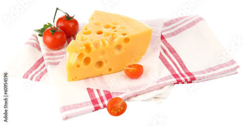 Photo: Piece of cheese and tomatoes,on color napkin, isolated on white Piece of cheese and tomatoes,on color napkin, isolated on white