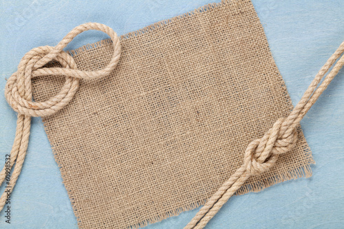 Photo: Ship rope on old wooden texture background Ship rope on old wooden texture background