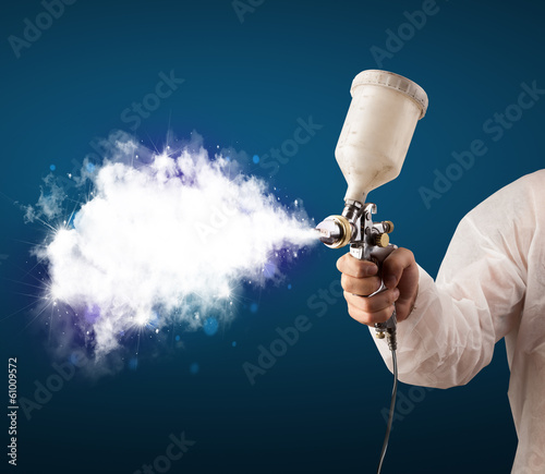 Photo: Painter with airbrush gun and white magical smoke Painter with airbrush gun and white magical smoke
