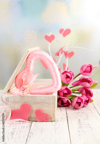 Photo: Romantic still life with heart in wooden casket Romantic still life with heart in wooden casket