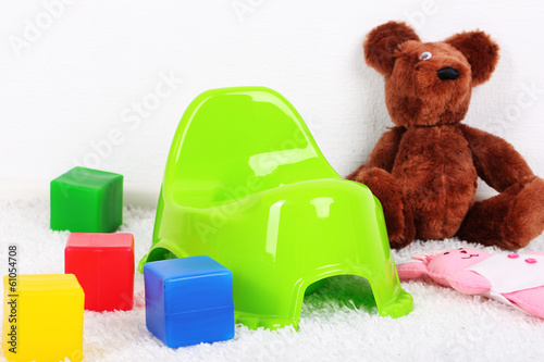Photo: Green potty on home interior background Green potty on home interior background