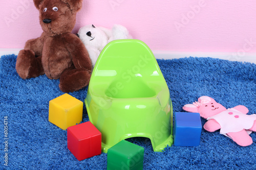Photo: Green potty on home interior background Green potty on home interior background