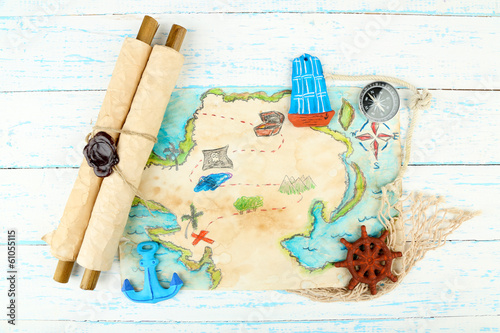 Photo: Treasure map with sea accessories, on wooden background Treasure map with sea accessories, on wooden background