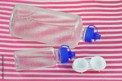 Photo: Bottles of Multi-Purpose Contact Lens Solution and a lens case Bottles of Multi-Purpose Contact Lens Solution and a lens case