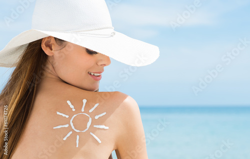 Photo: Sun Drawn On Woman's Shoulder With Sun Protection Cream Sun Drawn On Woman's Shoulder With Sun Protection Cream