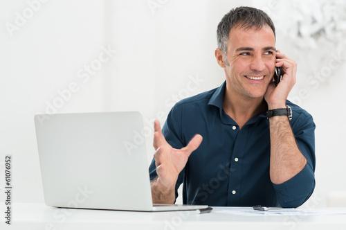 Photo: Smiling Man Talking On Cellphone Smiling Man Talking On Cellphone