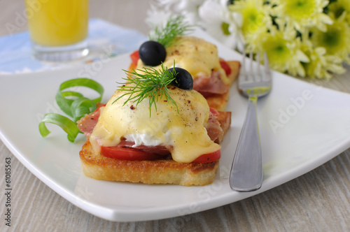 Photo: Eggs Benedict with ham and tomato on toast with cheese Eggs Benedict with ham and tomato on toast with cheese