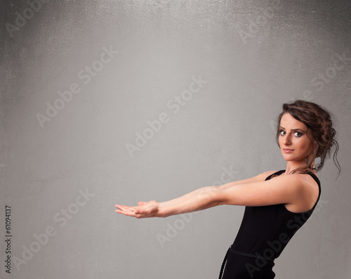Photo: Pretty woman presenting an empty copy space Pretty woman presenting an empty copy space