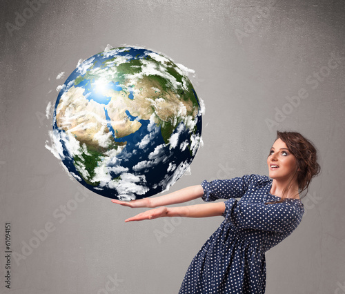 Photo: Pretty girl holding 3d planet earth Pretty girl holding 3d planet earth