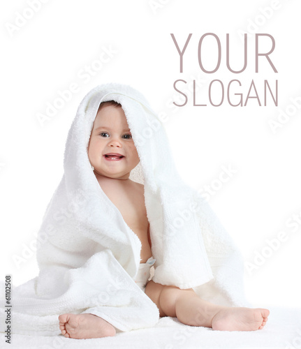 Photo: Cute baby girl with towel isolated on white Cute baby girl with towel isolated on white