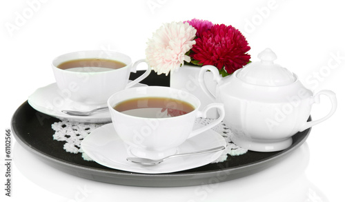 Photo: Cups of tea on tray isolated on white Cups of tea on tray isolated on white