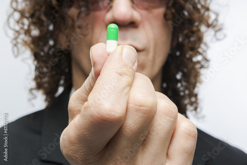 Photo: Man taking pill Man taking pill