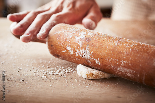 Photo: Hands baking dough with rolling pin Hands baking dough with rolling pin
