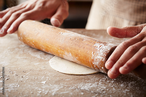 Photo: Hands baking dough with rolling pin Hands baking dough with rolling pin