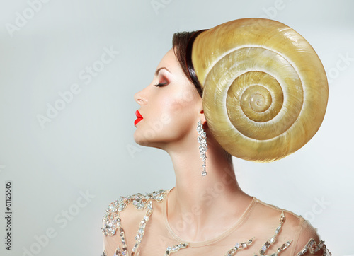 Photo: Extreme Hairstyle. Peculiar Woman with Snail. Headwear Extreme Hairstyle. Peculiar Woman with Snail. Headwear