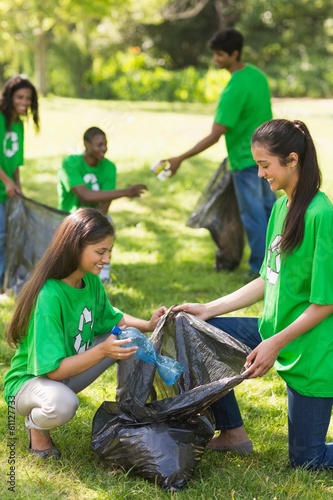 Photo: Team of volunteers picking up litter in park Team of volunteers picking up litter in park