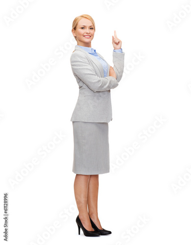Photo: smiling businesswoman with her finger up smiling businesswoman with her finger up