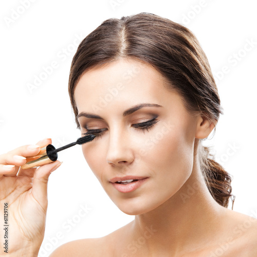 Photo: Young woman with cosmetics brush, isolated Young woman with cosmetics brush, isolated