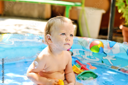 Photo: baby girl sitting in the pool baby girl sitting in the pool