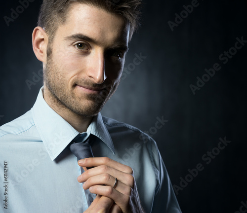 Photo: Adjusting necktie Adjusting necktie