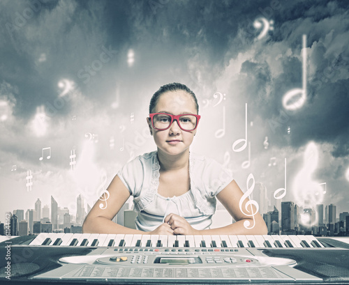 Photo: School girl with piano School girl with piano