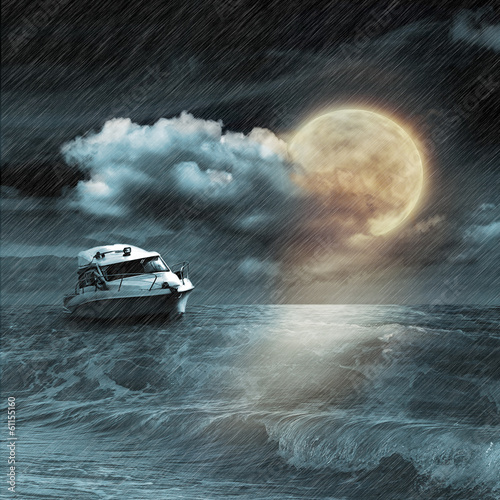 Photo: Boat in storm evening on ocean and the moon Boat in storm evening on ocean and the moon